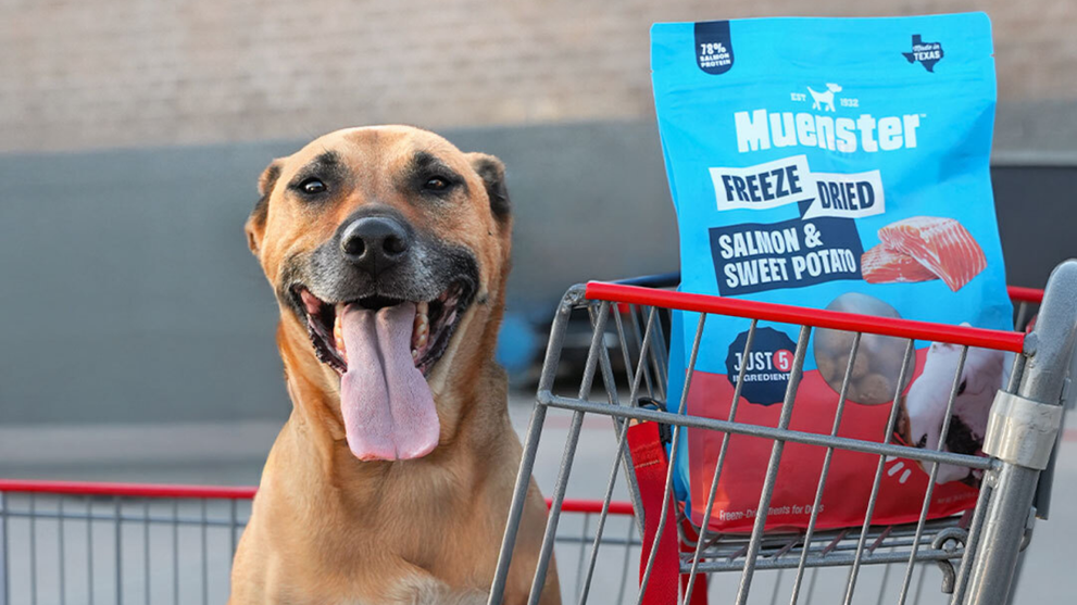 Tan Dog in Shopping Cart Next to a Bag of Muenster’s Freeze Fried Dog Food